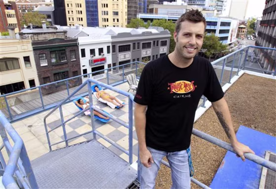 Hostel owner Robert Smith poses at the roof-top garden at the Jackaroo Hostel in Sydney's Kings Cross on Friday. Guests have extended their stays, sometimes for weeks, because of&nbsp;changes in plans for Queensland trips. The hostel has been turning away up to 15 guests a day, Smith said.&nbsp;Queensland is fighting to regain tourism after suffering&nbsp;deadly flooding and a huge cyclone. 